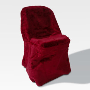 A chair dressed in luxurious red velvet fabric, elegantly complemented by our Chair Covers, stands against a plain background.