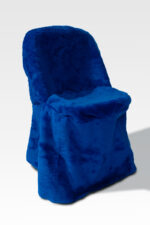A high-back chair covered in bright blue plush fabric features an elegant draped design, further enhanced by stylish Chair Covers.