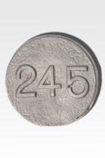 A round, textured token from the Cast Aluminum Lot Markers collection, showcasing the number 245 in embossed numerals.