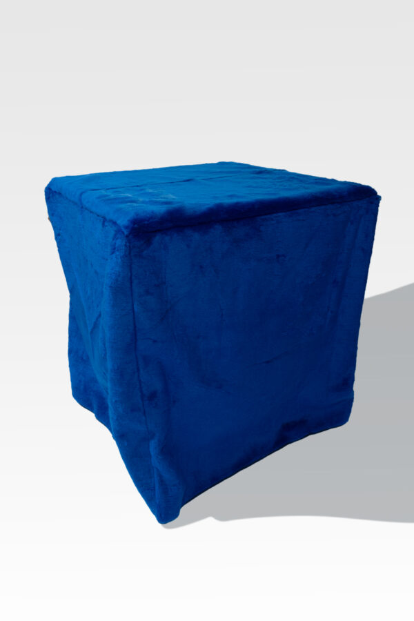 A blue, textured cube ottoman stands elegantly against a light gray backdrop, echoing the refined simplicity of the EZ Fold Cremation Stand design.