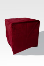 An EZ Fold Cremation Stand, shaped like a cube, is gracefully covered in red fabric on a stark white background.