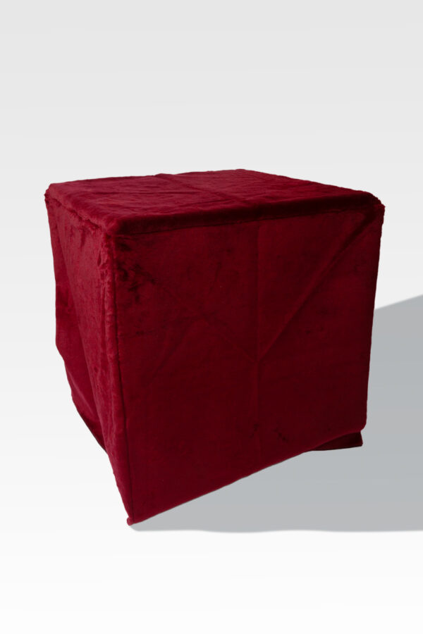 An EZ Fold Cremation Stand, shaped like a cube, is gracefully covered in red fabric on a stark white background.