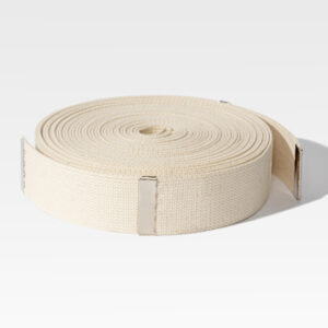 A rolled Hand Lowering Strap in beige, featuring metal clips on both ends, rests elegantly on a pristine white surface.