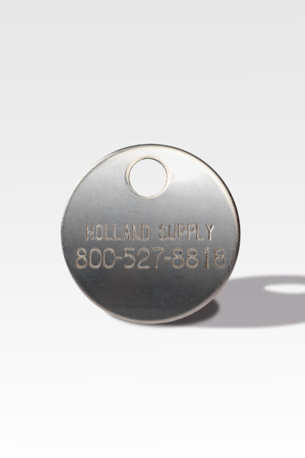 The Cremation ID Disc, a round metal tag, is typically used as a Cremation ID Disc and features the engraving "Holland Supply 800-527-8818," complete with a hole at the top for attachment.