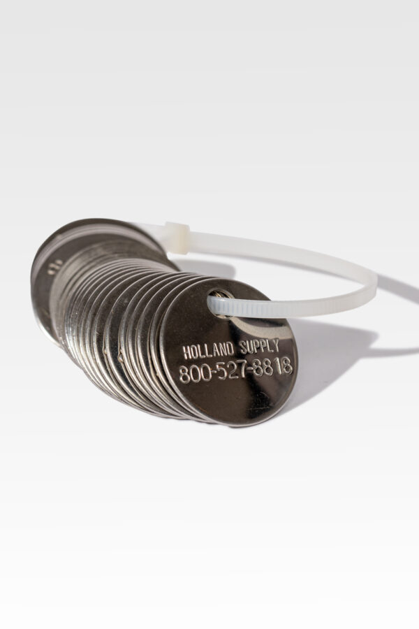 A set of Cremation ID Discs fastened with a plastic tie, featuring the engraving "HOLLAND SUPPLY" and a phone number for reliable and easy identification.