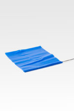A crumpled blue plastic sheet resembling Grave Identification Flags drapes over a metal bar against a light gray background.