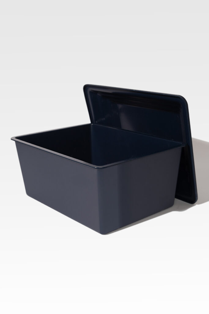 A Safeguard® Urn Vault, rectangular and black with a matching lid slightly ajar, displayed against a plain background.