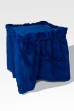 A plush blue ottoman with a skirt-like cover stands gracefully against a neutral backdrop, reminiscent of the timeless elegance found in the Stainless Steel Cremation Stand.