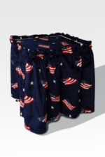 A drum with an American flag design featuring stars and stripes on a dark blue background sits atop a sleek Stainless Steel Cremation Stand, blending tradition with contemporary elegance.