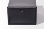 This black plastic Temporary Cremation Container, embossed with "Holland Supply Inc.," includes recycling symbols and "Made in the USA" text, highlighting its practical design and commitment to sustainability.