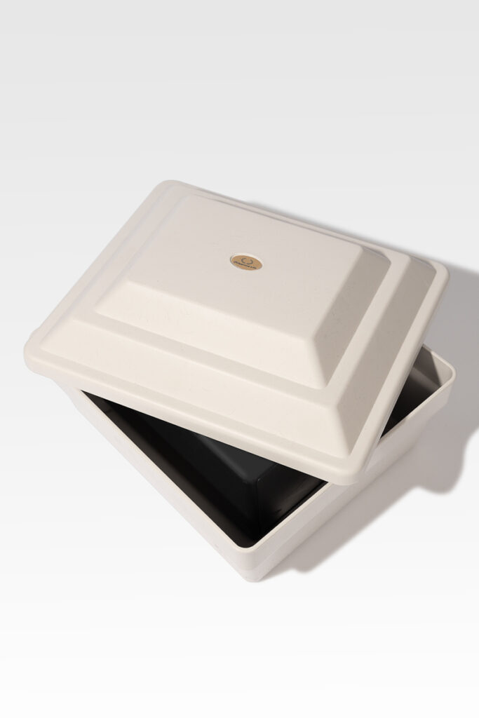 A partially open rectangular white Cremains Urn Vault reveals a dark interior.