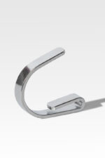 A silver metal clip shaped like the letter "C" is displayed upright against a plain, light gray background.