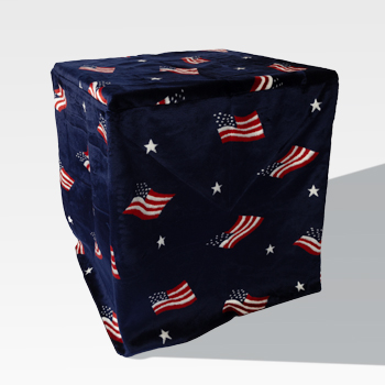 A dark blue cube-shaped object covered with a fabric featuring American flags and white stars.