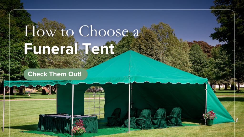A large green funeral tent with chairs and flower arrangements is set up on a grassy lawn, surrounded by trees under a clear sky.